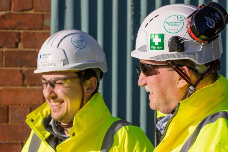 These men are recognisable as mental health first aiders by the stickers on their safety helmets