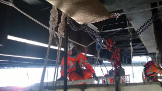 CAN technicians are constantly on hand during the repair work and(inset): Metalock's workers are winched up from the barge by a powered ascender system