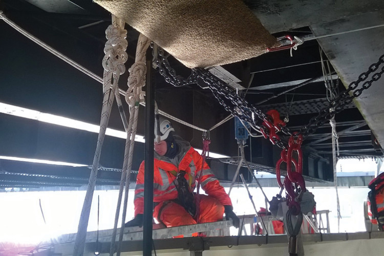 CAN technicians are constantly on hand during the repair work and(inset): Metalock's workers are winched up from the barge by a powered ascender system