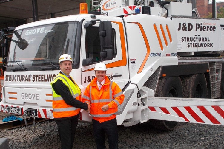 Manitowoc Grove UK sales manager Jerry Welford hands over the new cranes to J&D Pierce managing director Derek Pierce