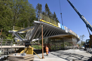 The bridge's stainless-steel skeleton was brought to site in four pieces