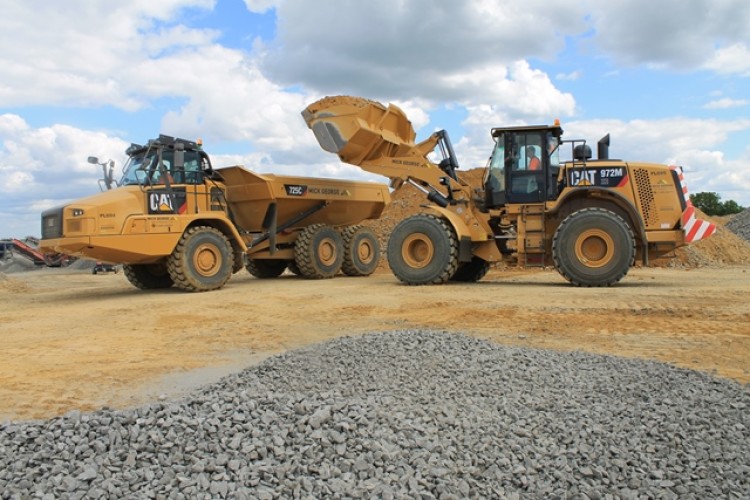  Cat 972M wheel loader with Cat 725C ADT