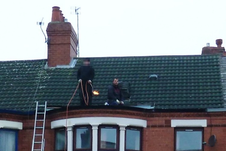 Daniel Loftus, right, with a labourer holding a lit gas burner