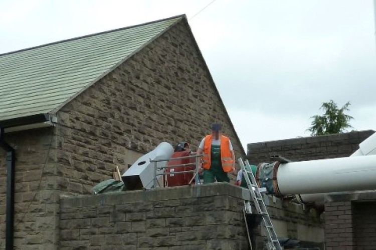 Workers on the roof of Morriston Crematorium in Swansea