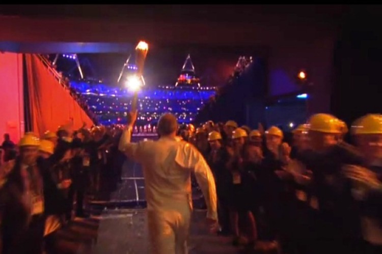 Construction's guard of honour as Sir Steve Redgrave brings the flame into the stadium