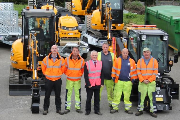 Cllr John Brunt (third from right) and members of the council's highways team are pictured with some of the new JCB equipment