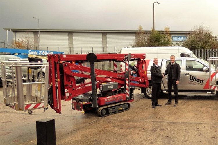 Mike Weatherill of APS hands over a Hinowa boom to Liam Stericker of Lifterz