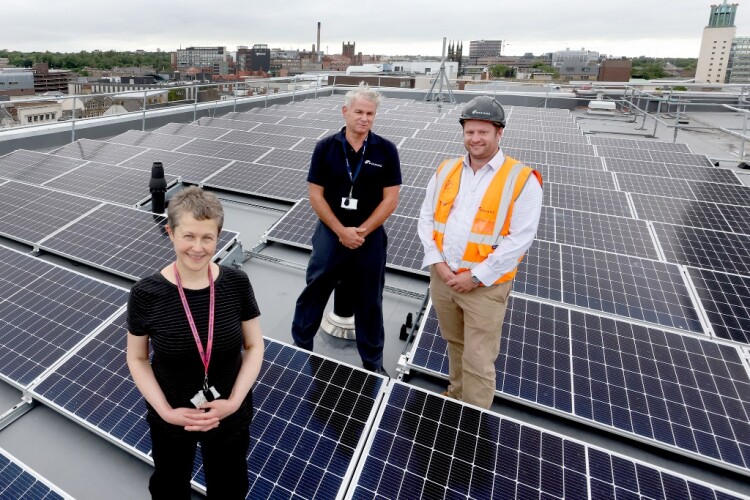 Cllr Jane Byrne with Equans director Tim Wood (centre) and operations manager Joe Logan on the roof of Newcastle Central Library