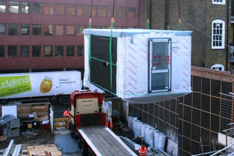 The first studio pod is lowered into place