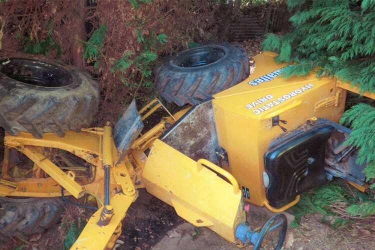 The skip loader on its side following the incident