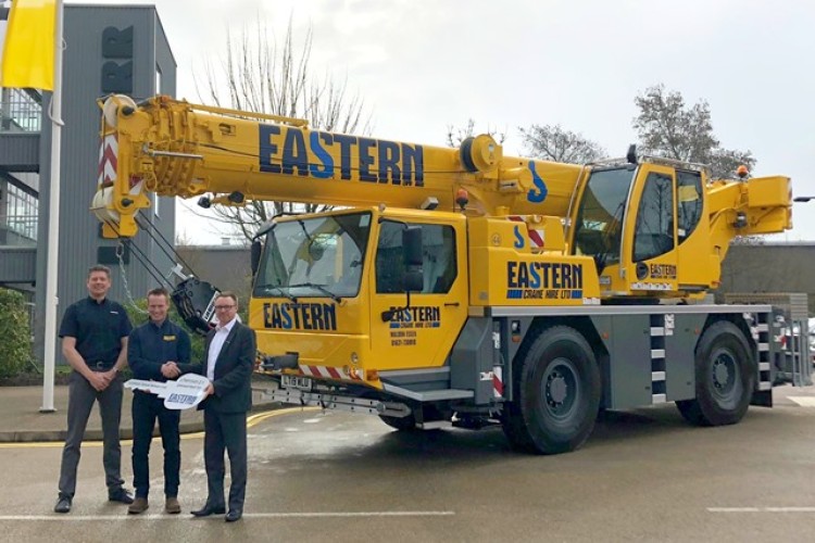 Eastern Crane Hire director Christopher Ashworth flanked by Liebherr&rsquo;s Tony Gribble (left) and Steve Elliott (right) with the new LTM 1040-2.1