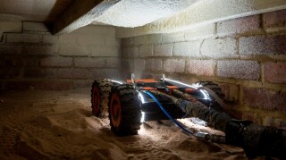 Q-Bots install insulation under floors with minimal disruption