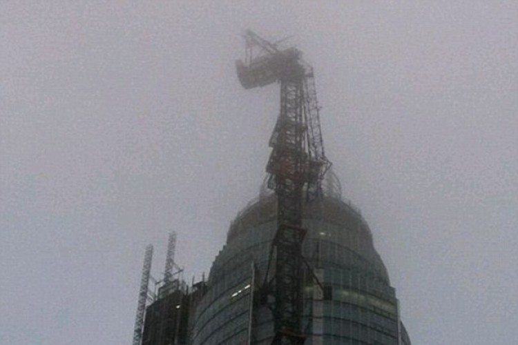 This photo of the dangling crane was posted on Twitter after the crash