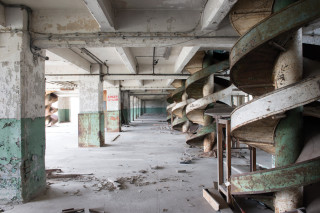 Some original features, including these old grain chutes, were left in place during the asbestos removal work. Floors, walls, ceilings, pipework and machinery were all potential asbestos hazards