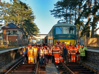 The permanent way team poses for photographs after completing the track up to Broadway