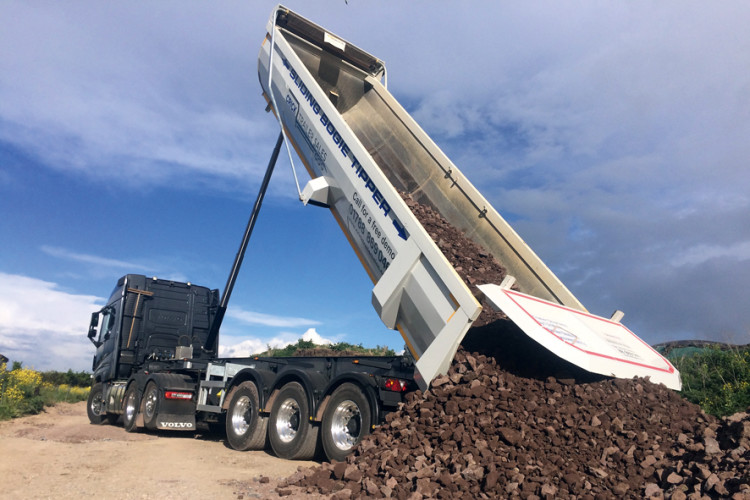 Left: The sliding bogie tipper trailer has been tested and found to be stable on a side-slope of up to 8.5°. Right: The sliding tipper is said to offer 9.8 tonnes more payload than a rigid tipper lorry