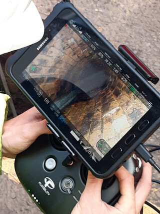 The operator pilots the drone through the sewer using video for visual inspection and LiDAR for measurement