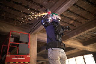 The EksoVest uses actuator springs to support the wearers arms during overhead work