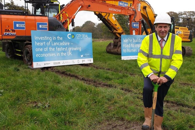 Lancashire County Council leader Geoff Driver cuts the first turf