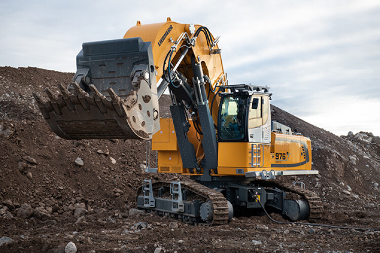The Liebherr R 976-E plugs into an electricity power source
