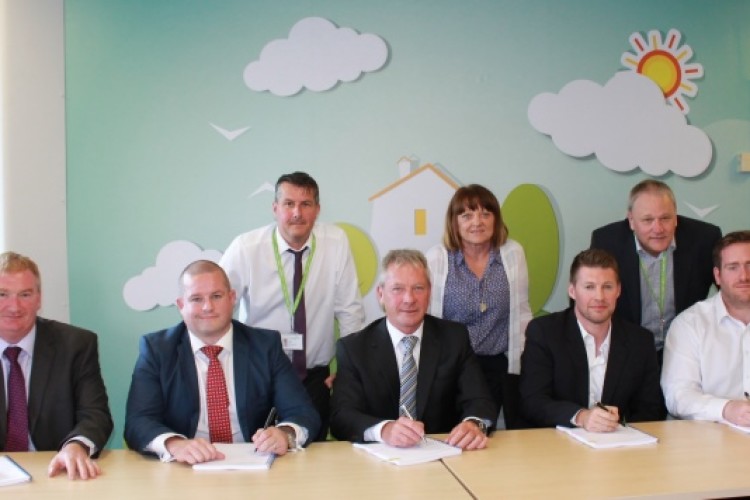 Contractors sign up. Front: Kieran McDonnell, Michael Hyde, John Gallagher, Chris Connolly and Richard Abbots. Back: Simon Stott, Sue Sutton and Steve Haywood from Salix Homes