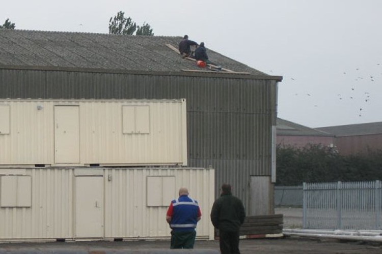 The two men working on the roof