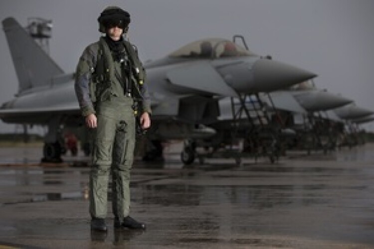 A pilot from 6 Squadron, RAF Lossiemouth, in front of a line of Typhoon aircraft. Crown Copyright MOD 2016. 