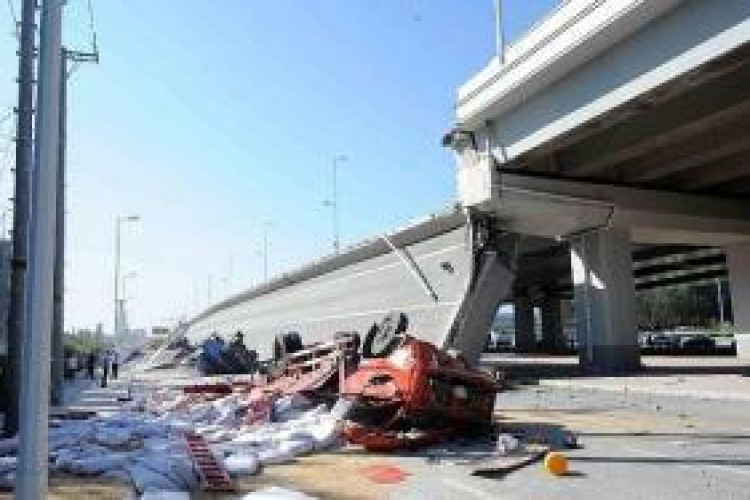 Xinhau reports that four trucks fell from the bridge approach.