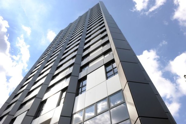 Grenfell Tower, before the fire, clad in aluminium composite material 