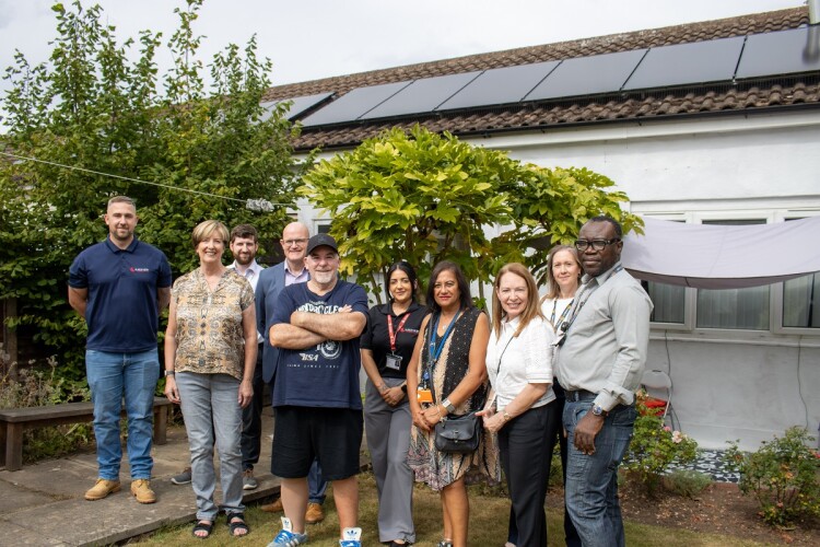 Stephen Cracknell (centre, in cap) says the work on his home has saved two thirds from his heating bills