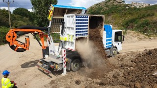 The truck demonstrates how excavated material is discharged