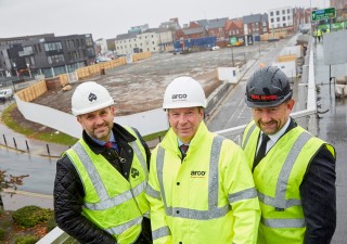 Dominic Gibbons of Wykeland Group, Arco’s David Evison and Richard Beal of Beal Homes, with the Fruit Market site in the background