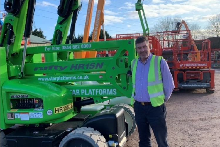 Managing director Richard Miller with a delivery of new machines including the Niftylift HR15N Hybrid articulating boom lift