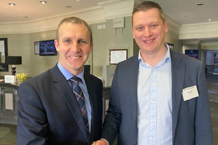 Michael Matheson (left, pictured with Tarmac's Ben Garner) said that the grant help ensure that rail remains the key mode of transport for much of Tarmac&rsquo;s operations