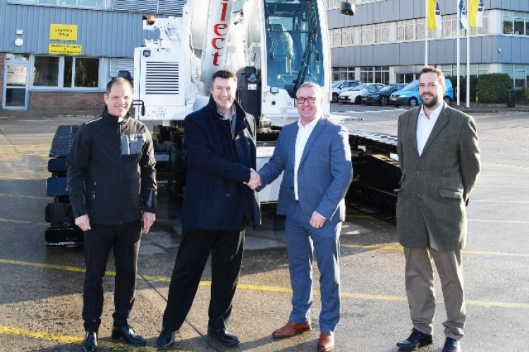 Mark West and Richard Everist from Liebherr (left and second left) hand over the LTR 1060.1 to Alex Warrington and Eddie Carr (right) of Select