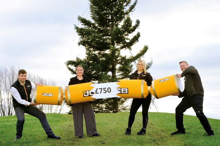 JCB employees Toby Bell, Holly Broadhurst, Kait Williams and Kevin Pickles recreate the traditional JCB Christmas bonus pose