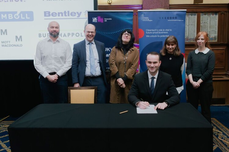 Scottish Water procurement manager Chris Arnold signs the AMC