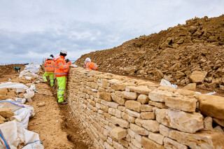 Up to 6.5km of dry stone wall is being built to help soften the visual impact of the scheme
