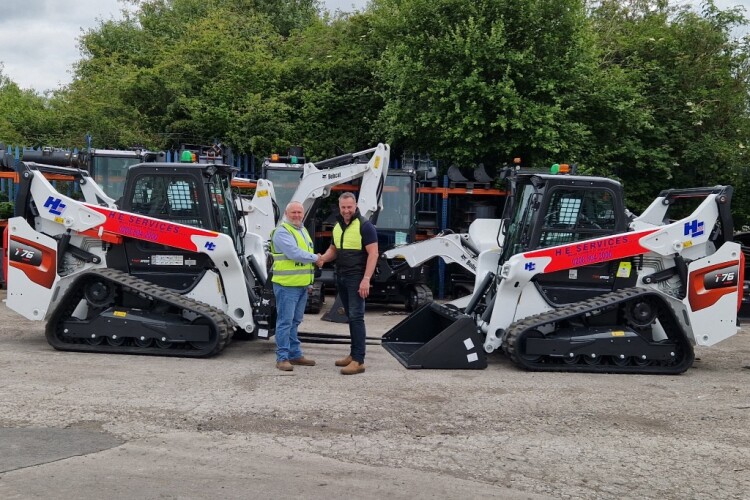 Doosan-Bobcat sales manager Graham Deacon hands over the new Bobcat machines to HE Services eastern area director Chris Larcom