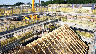 The inside cantilever brackets are initially left out to ensure that the roof has sufficient room to be craned out without catching the scaffold