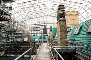 Extensive scaffolding beneath the temporary roofs provides comprehensive access for restorers at Manchester Town Hall.