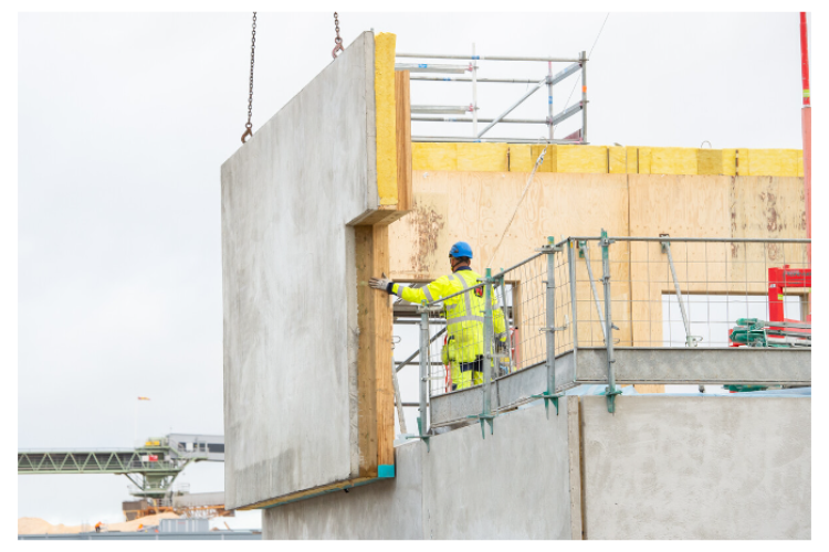 Combining precast concrete and timber could reduce carbon emissions without compromising structural performance, the companies claim.