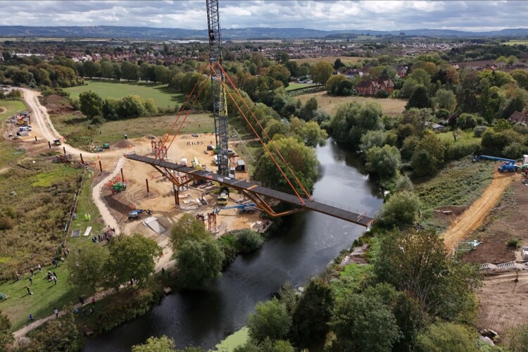 Lifting the bridge into place, courtesy of Griffiths/Time Lapse UK