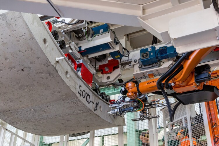 Kuka robot on the Herrenknecht TBM places dowels in a lining segment