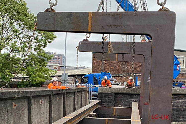Steel I-beams were bolted to the C-hooks to support the entire length of the bridge 
