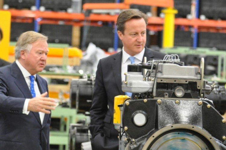 Sir Anthony Bamford shows David Cameron a JCB Dieselmax engine at the new Brazil factory
