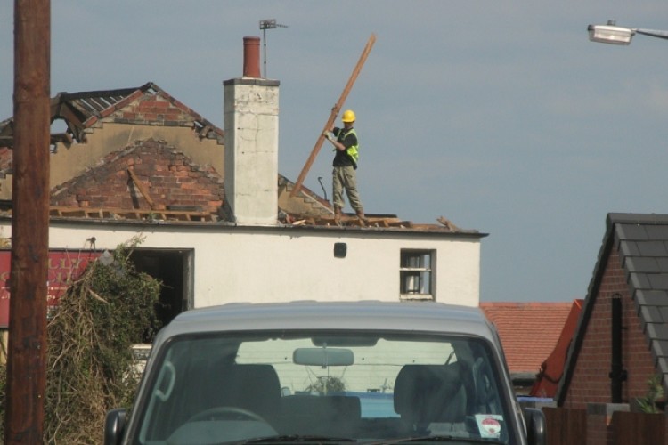 Worker on the roof of the former Jolly Colliers pub