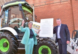 Roads minister Lilian Greenwood and JCB's Tim Burnhope with the signed statutory instrument Roads minister Lilian Greenwood and JCB's Tim Burnhope with the signed statutory instrument