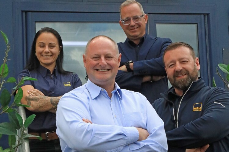 Tim Young (centre) with the Mr Plant Hire team