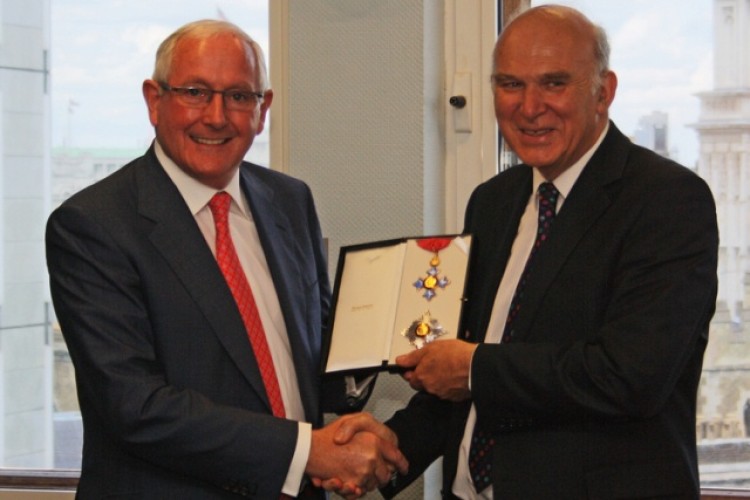 Vince Cable (right) gives 'Sir Ray' his honorary knighthood